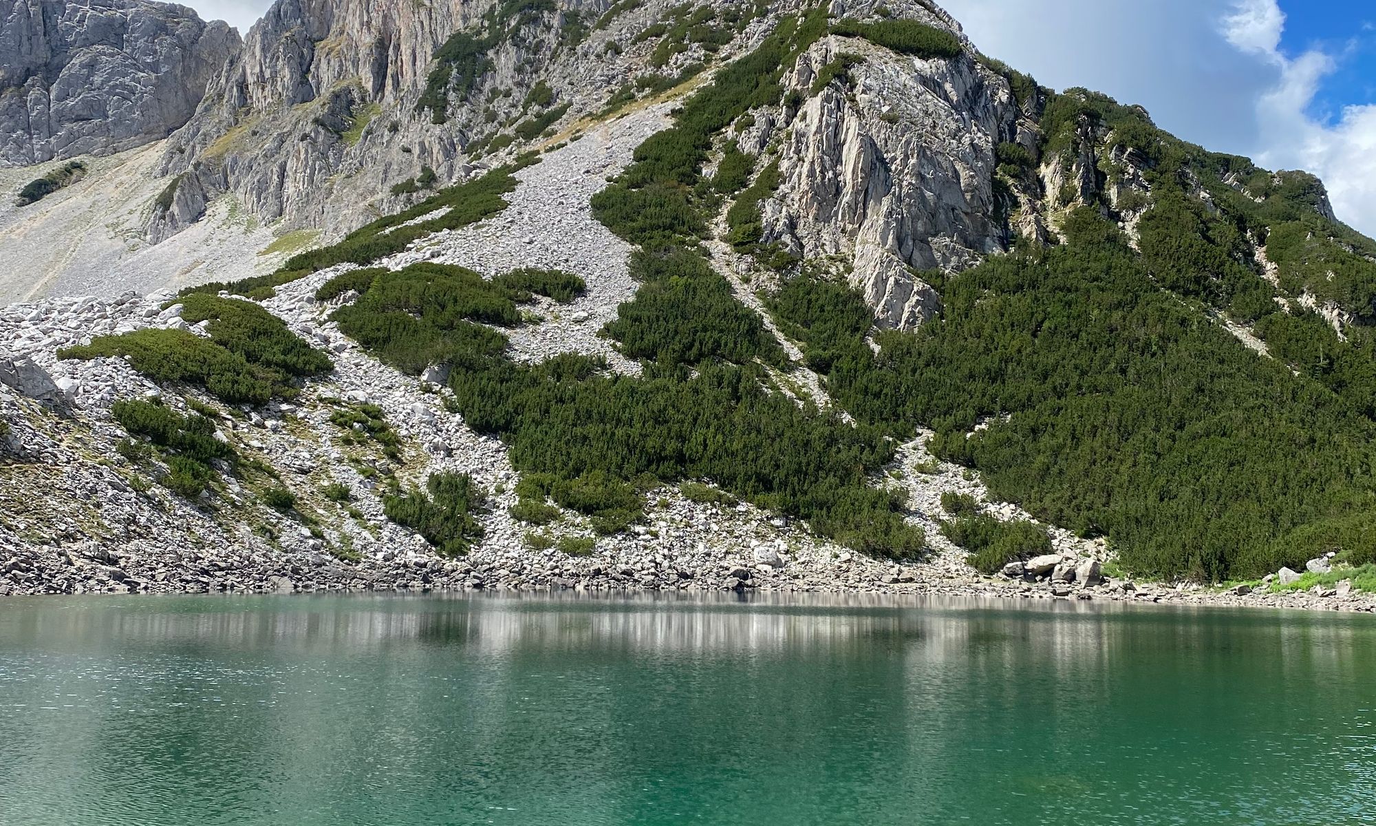 Rocky ridge reflected in a lake in the Pirin mountains, Bulgaria. Photo by Denis Krempasky.